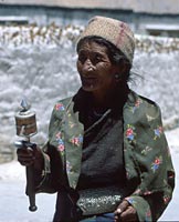 Lady spinning a prayer wheel