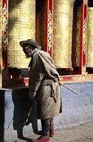 Man spinning prayer wheels